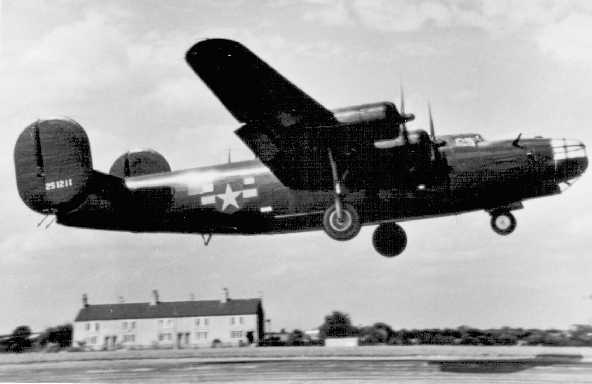 B24 Miss Fitts taking off in front of the Foxhall Cottages